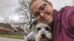 Megan showing love to a happy dog during a walk in Columbus, Ohio.